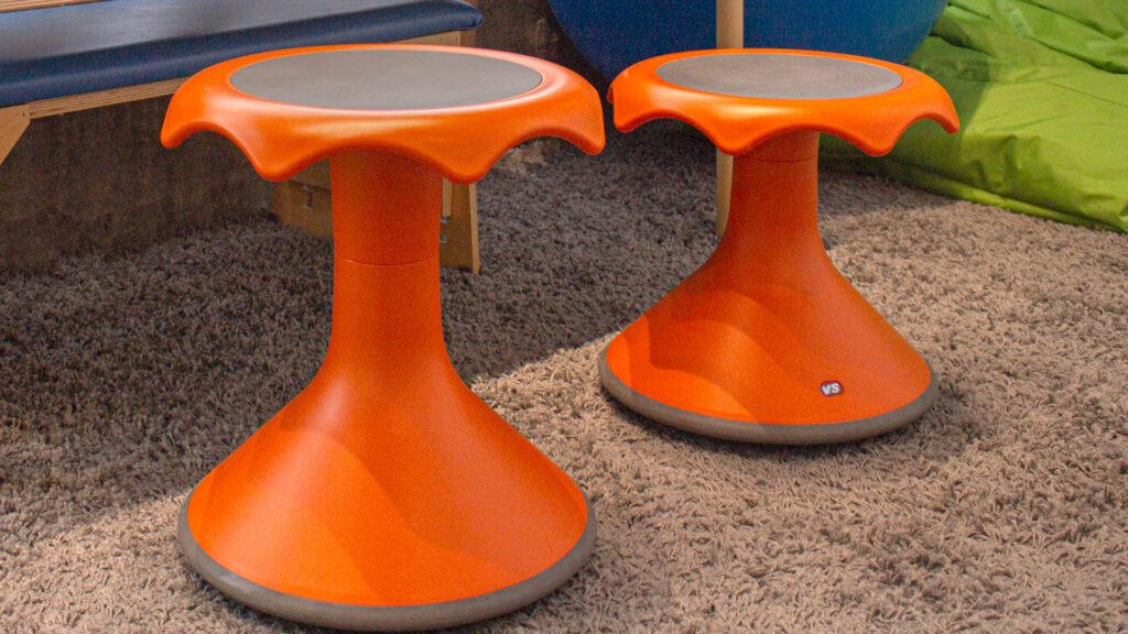 two orange wobble stools